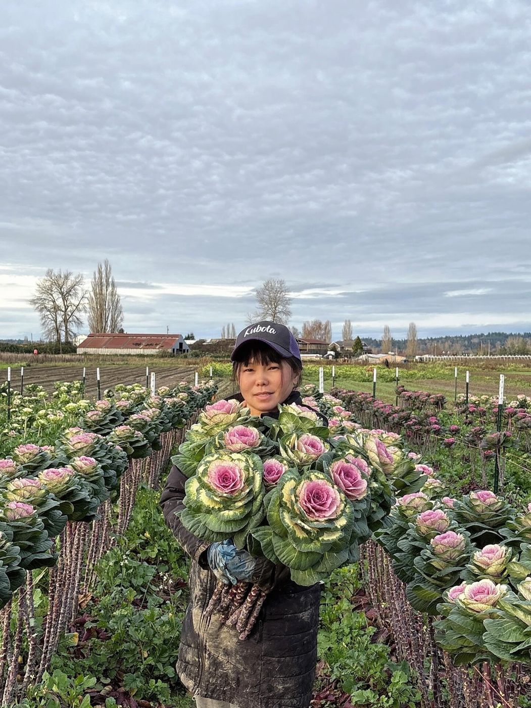 A Thai D Garden grower holding ornamental flowers in the field